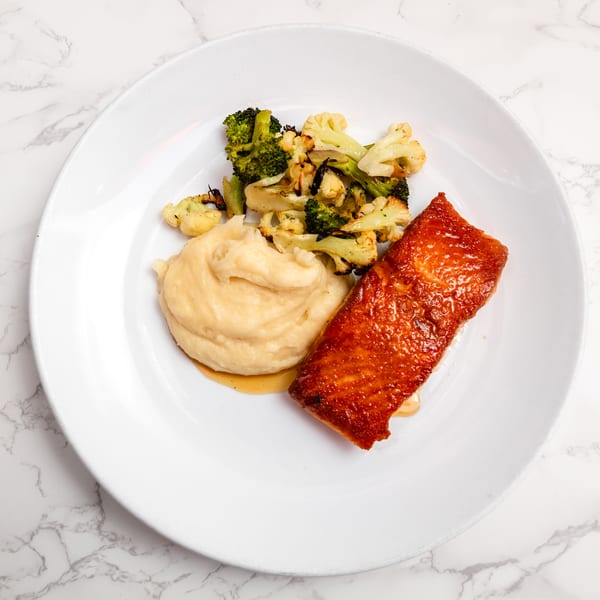 Pan-seared salmon with honey peppercorn glaze at Cracked Pepper Bistro.