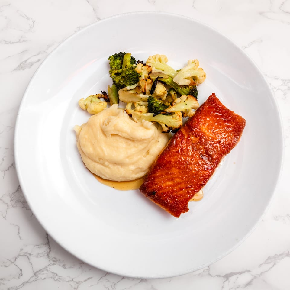 Pan-seared salmon with honey peppercorn glaze at Cracked Pepper Bistro.
