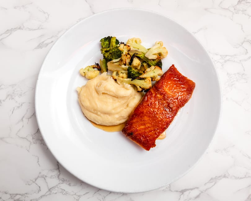 Pan-seared salmon with honey peppercorn glaze at Cracked Pepper Bistro.